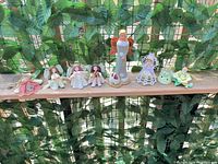 Full view of all seven figurines and ornaments on shelf