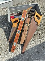 Lot overview showing 2 hand saws, levels and tool bin