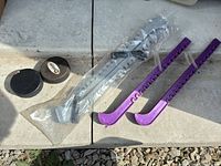 Full lot showing two pucks, packaged silver guards, loose purple guards