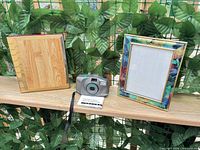 All items: camera, manual, strap, photo album, picture frame