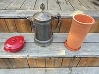 All three items: red casserole with lid, silver-plated pot, terracotta wine cooler and drip tray