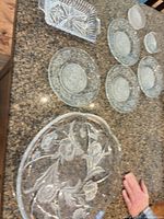 All six pressed glass pieces on countertop