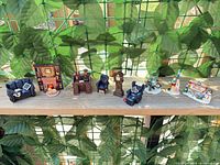 All eleven resin miniature pieces lined up for scale and style overview