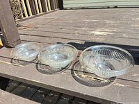 All three clear ribbed glass bowls side-by-side on deck