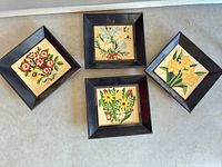 Overview of three framed floral artworks