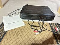 Front and top view of Sony SLV-400 VCR with manual and RCA cable visible
