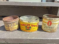 Front view of three tins: Dixie, World’s Navy, Turret showing graphics and wear