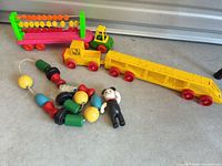 All items grouped: counting truck cab and trailer, flatbed trailer, bead string, figure
