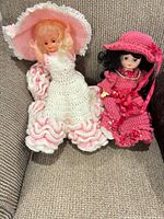 Both dolls seated on sofa