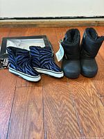 Both pairs of Vans winter boots with box visible
