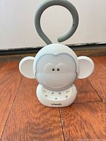 Front view showing VTech monkey soother with control buttons and LED panel