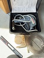 open case showing sprayer, jar, tubing and manual