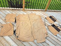 All five WeatherTech tan protectors laid out: large seat cover, two door panels, two square covers