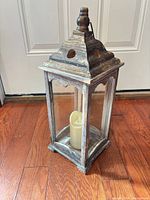 Front view of wood and glass lantern with LED candle inside