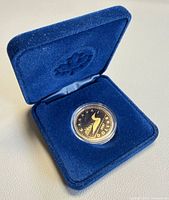 Coin in open blue velour case