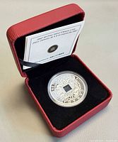 Coin in capsule inside red RCM case