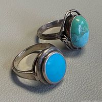 Both sterling silver turquoise rings top view displaying stone colors and settings