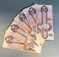 Fan arrangement of five Canadian $2 bills showing obverse side