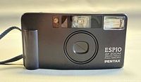 Front view of Pentax Espio AF Zoom camera showing lens cover, flash, model text