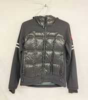 Full front view of jacket on hanger displaying overall design and condition