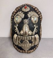 Front view of mask showing overall design and metal features