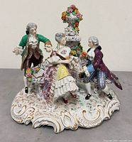 Front view of porcelain figural group showing three figures and base