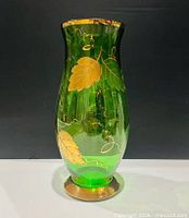 Full view of green glass vase standing upright