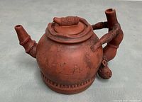 Front/side view showing bamboo-style spout, handle and overall form