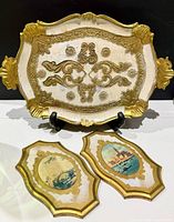 Tray and two plaques grouped to show lot contents and comparative sizes