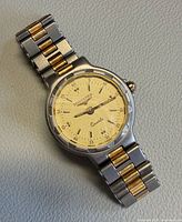Full view of watch showing dial, bracelet, and two-tone design