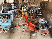 Full view of Ariens tiller showing handlebars, engine, tines, wheels