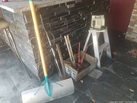 Group shot showing tamper, ladder, box of hand tools and additional bar