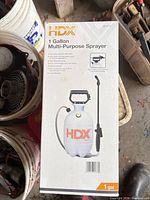 Boxed HDX 1-gallon sprayer next to buckets of parts