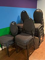 Stacked group of metal frame banquet chairs showing upholstery pattern and overall design
