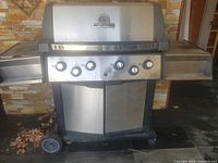 Front view of stainless steel Broil King Sovereign XL grill with five knobs and side shelves