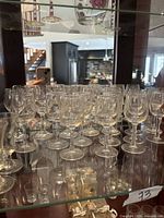 shelf with multiple small stemmed glasses