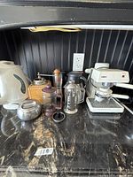 Group view of all coffee appliances and accessories on countertop