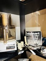 Cuisinart food processor base, work bowl, accessories, manual visible