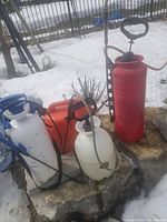 Group shot showing three sprayers and fuel jug