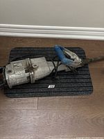 Full view of jackhammer with chisel and cord