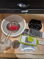 Drawer view showing all seven utensils grouped