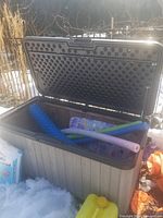 deck box open showing interior and pool toys