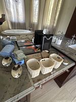 Overview showing hair dryer boxes, heater, baskets, toiletries on counter