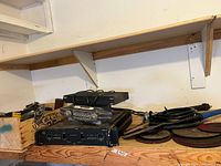 Shelf with Bell receiver, vintage radio, QSC amplifier, discs, cables