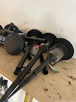 Pile of eight black solar stake lights showing lamp heads, stakes, and attached labels