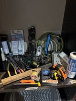 Overview of tools including tape measures, knives, adapter, extension cord