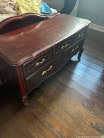 Front view showing faux drawers and brass hardware