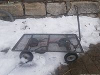 Side view of metal mesh flatbed cart showing wheels and handle