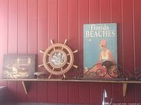 Overall view of all five items on shelf against red wall