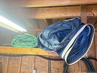 Blue and green rolled tarps on shelf